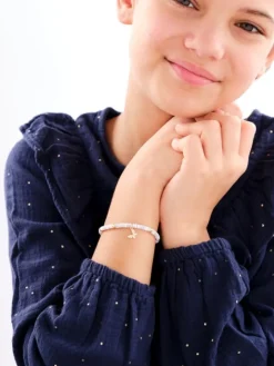 Bransoletka dla dziecka z mosiądzu pozłacana z muszlą i cyrkoniami - motyl